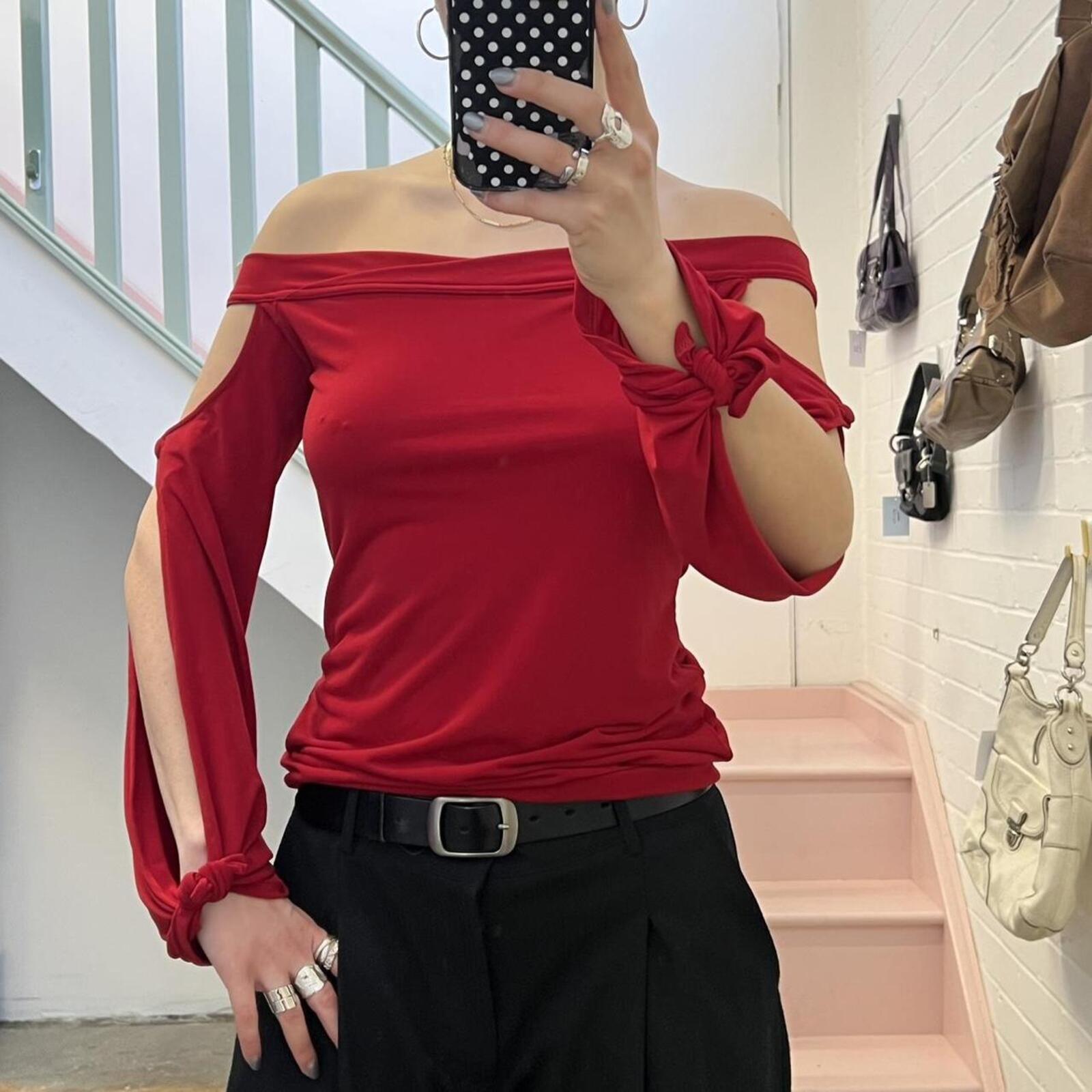 red slouchy off shoulder flared sleeve top with cutout detail