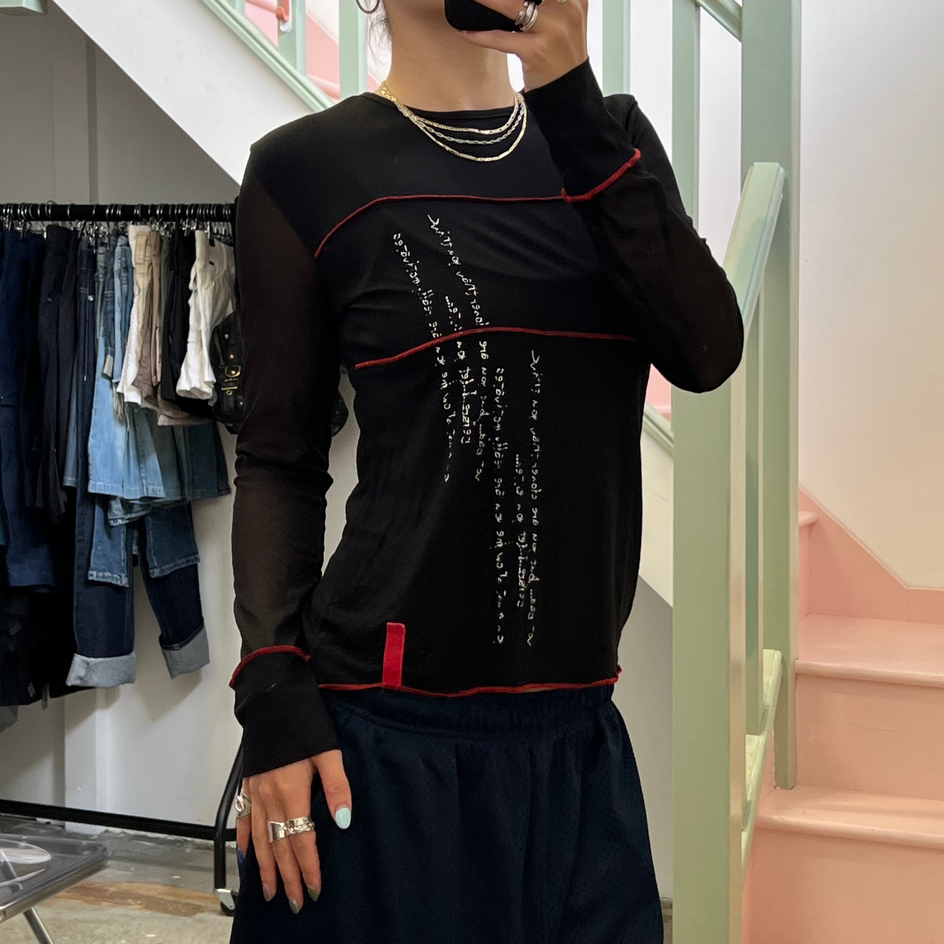 Black long sleeve top with red contrast stitch