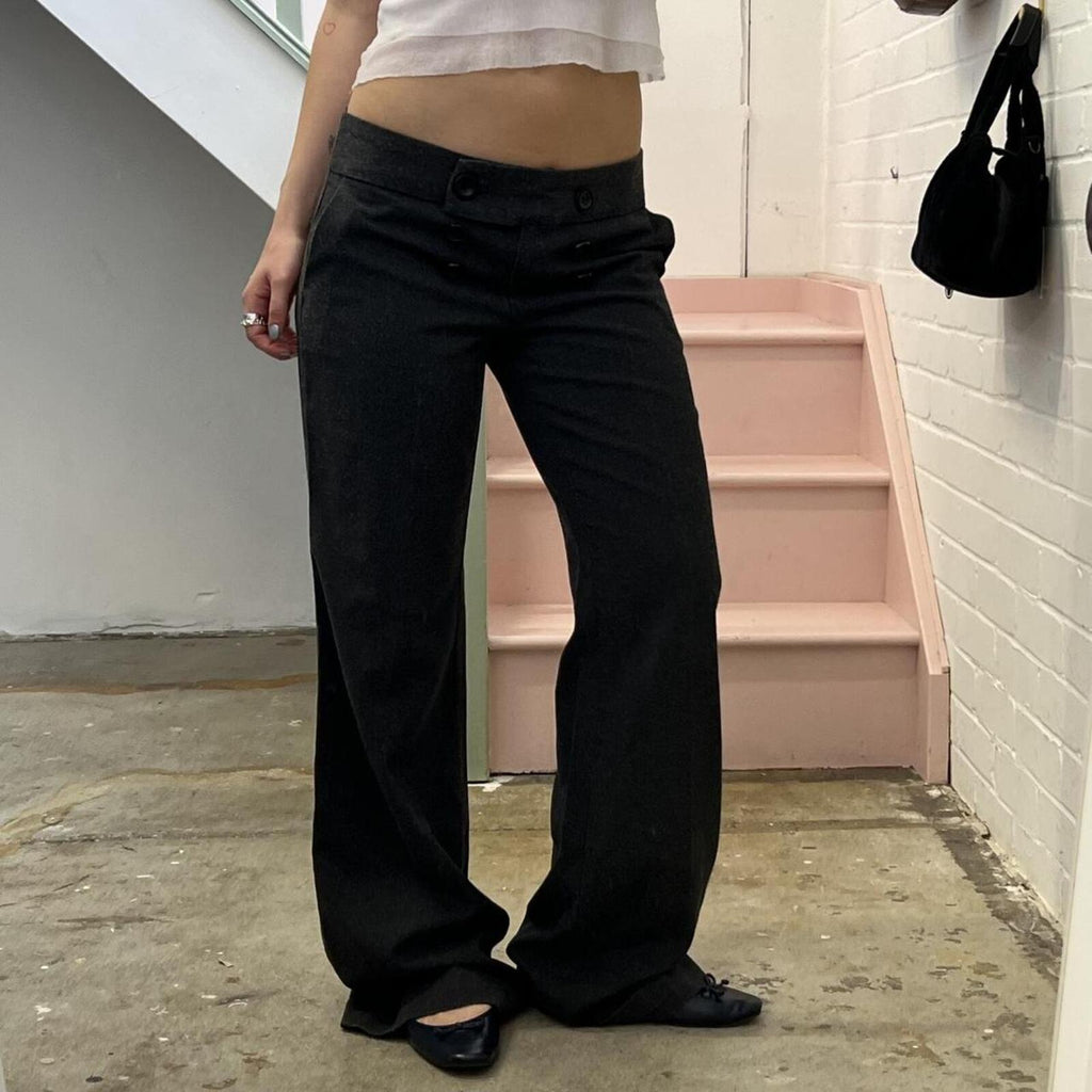 Grey low rise wide leg tailored trousers with oversized buttons on the waistband
