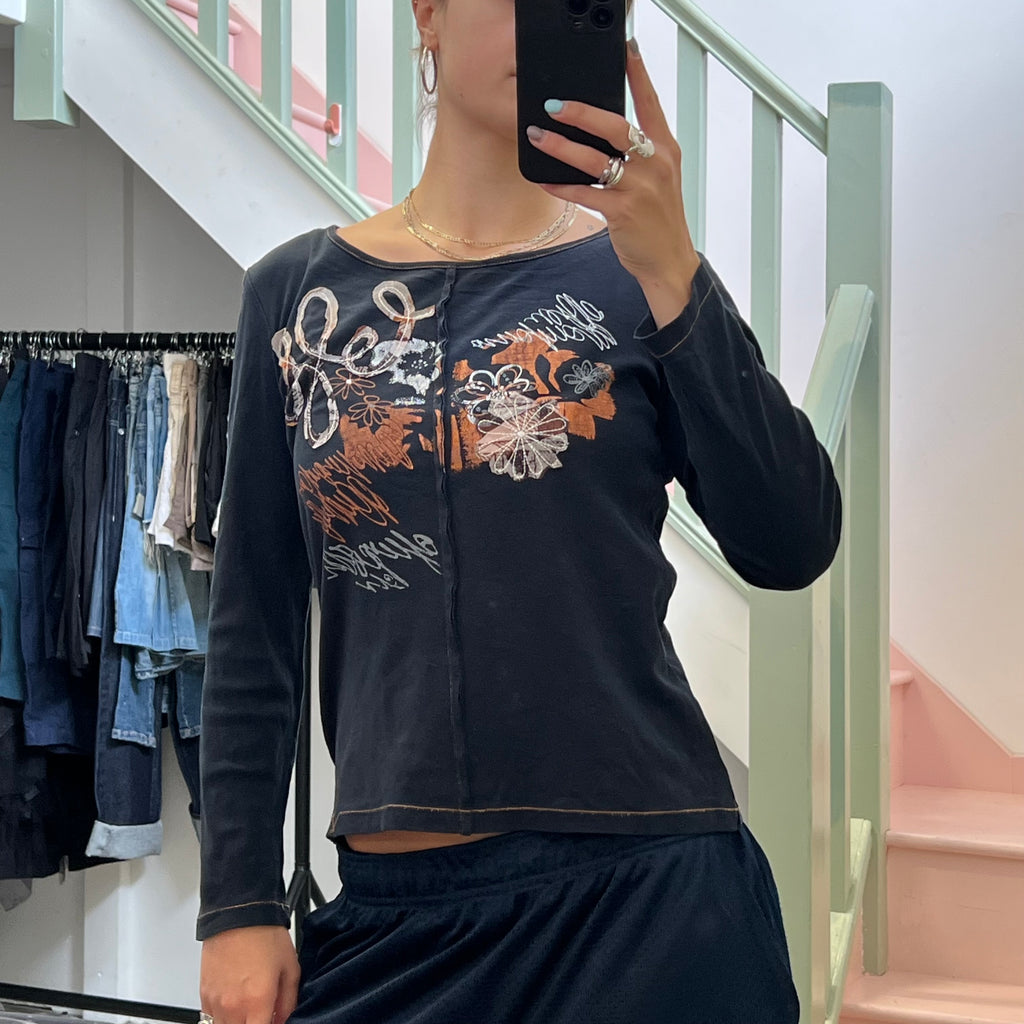 Black and orange graphic print top