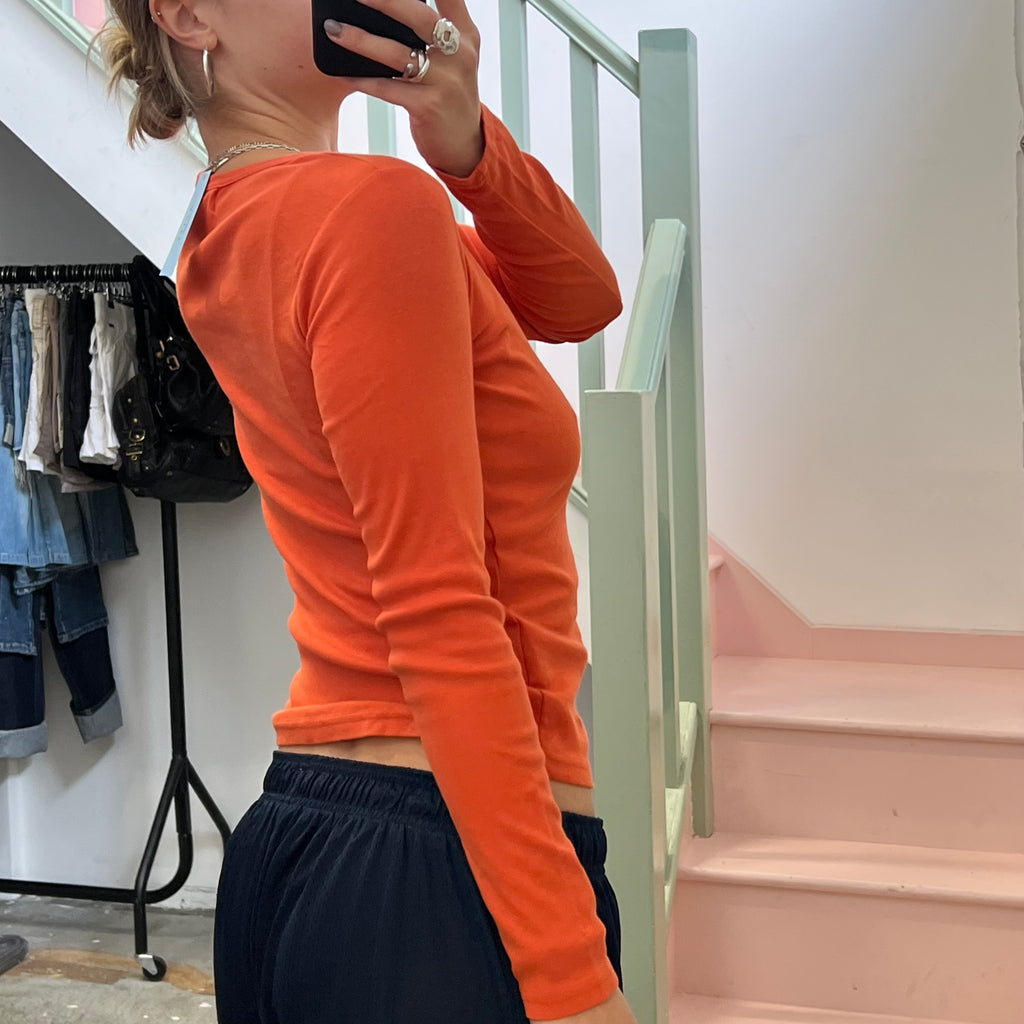 Cache orange top with pin detail