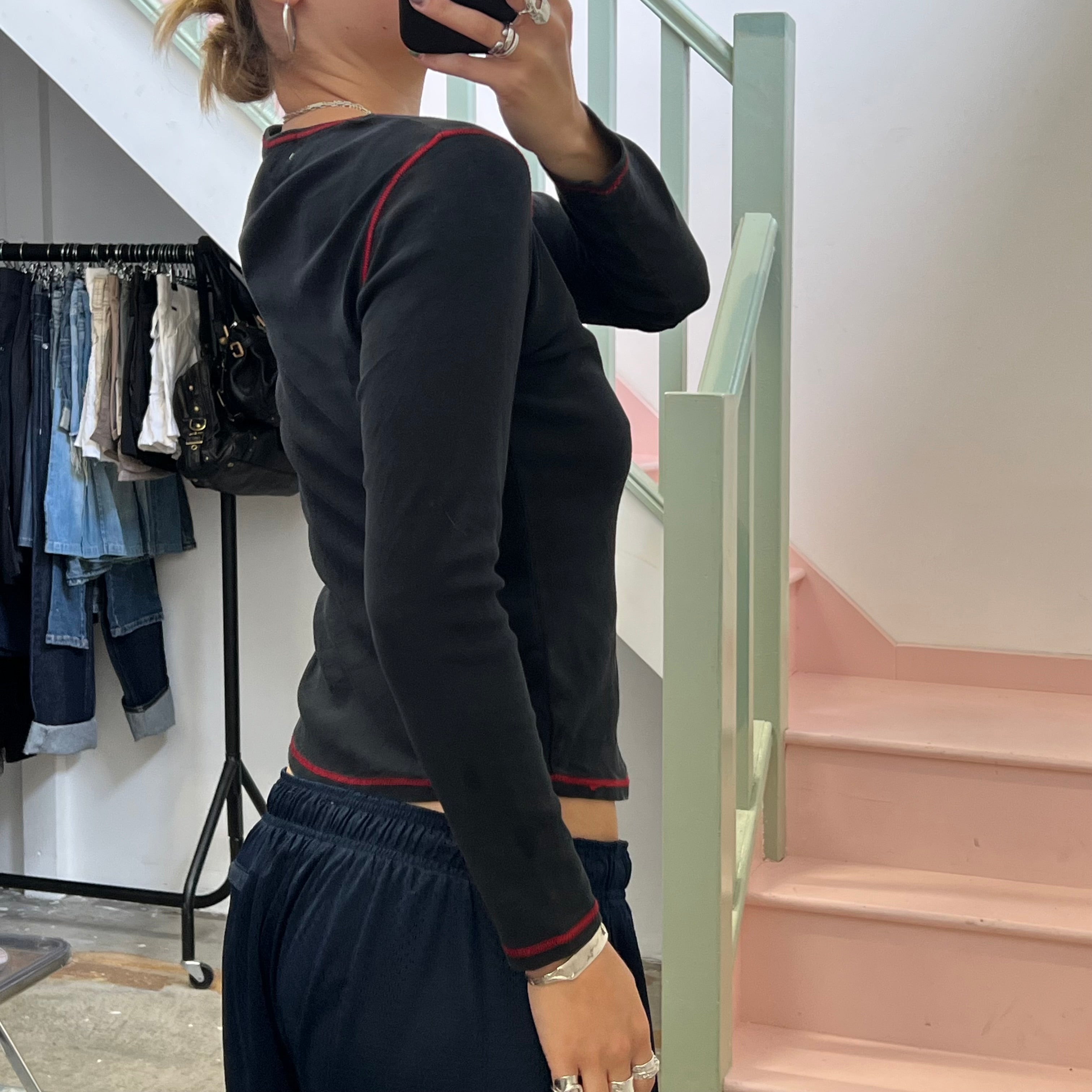 Black graphic top with red contrast stitch