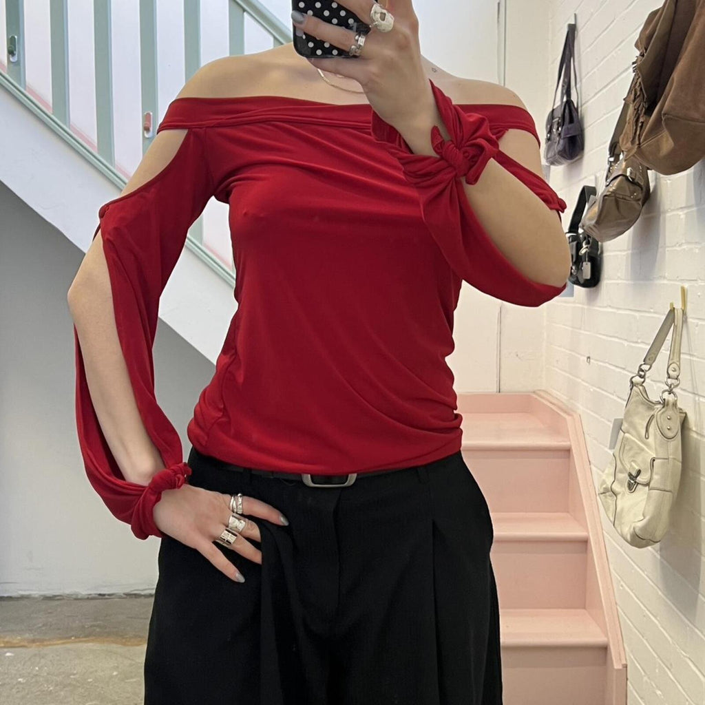 red slouchy off shoulder flared sleeve top with cutout detail