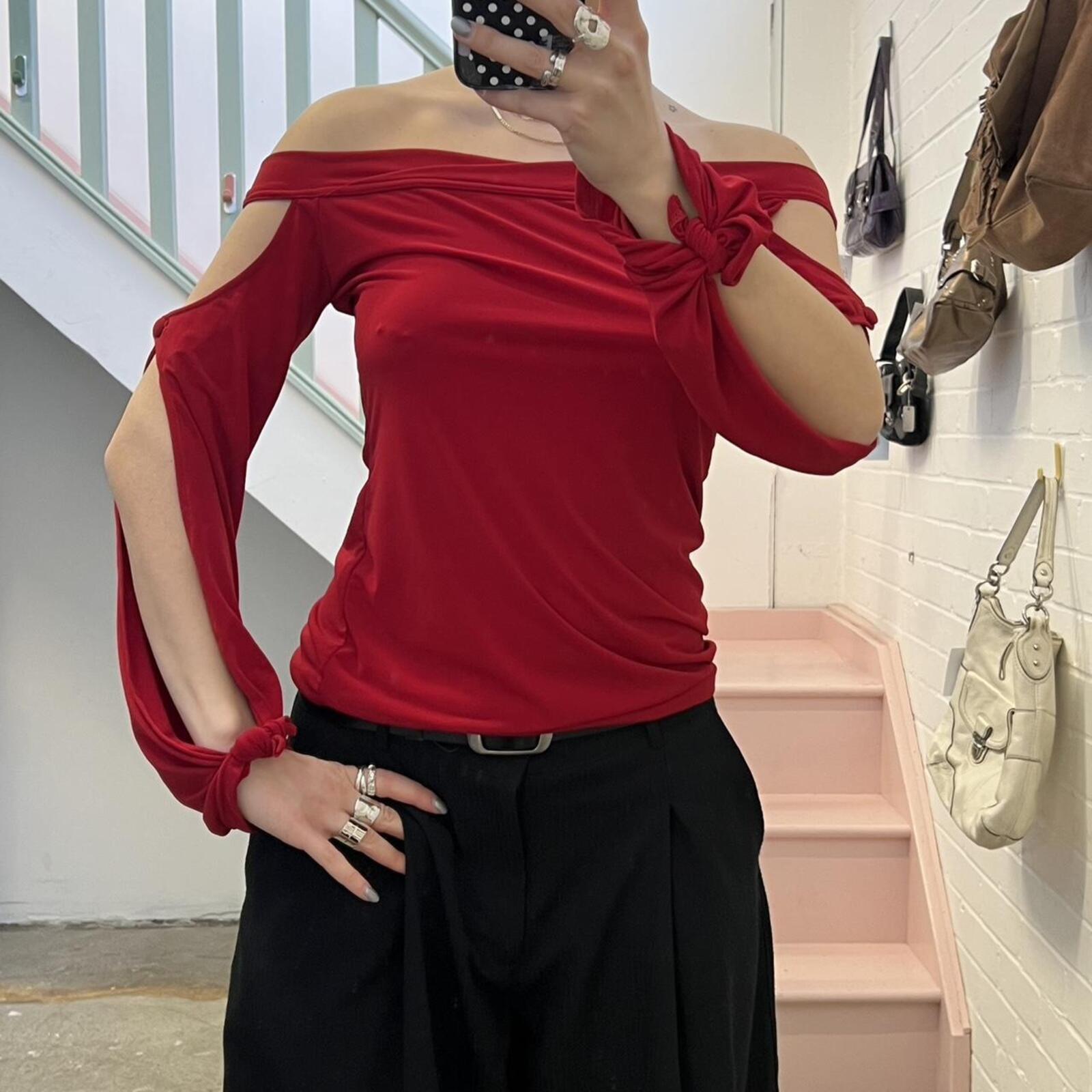 red slouchy off shoulder flared sleeve top with cutout detail