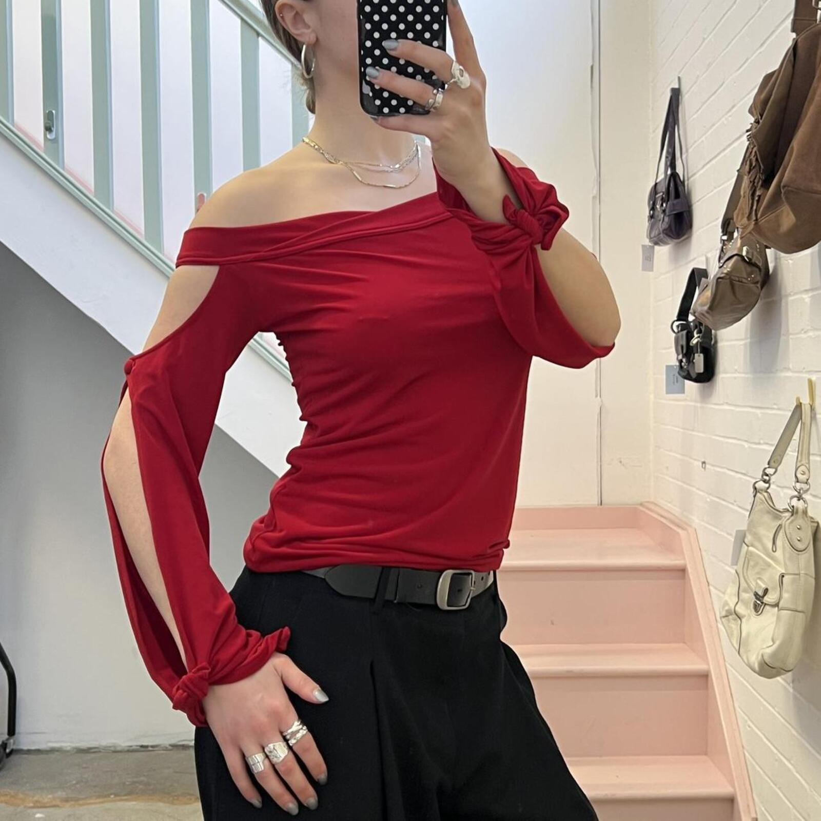 red slouchy off shoulder flared sleeve top with cutout detail