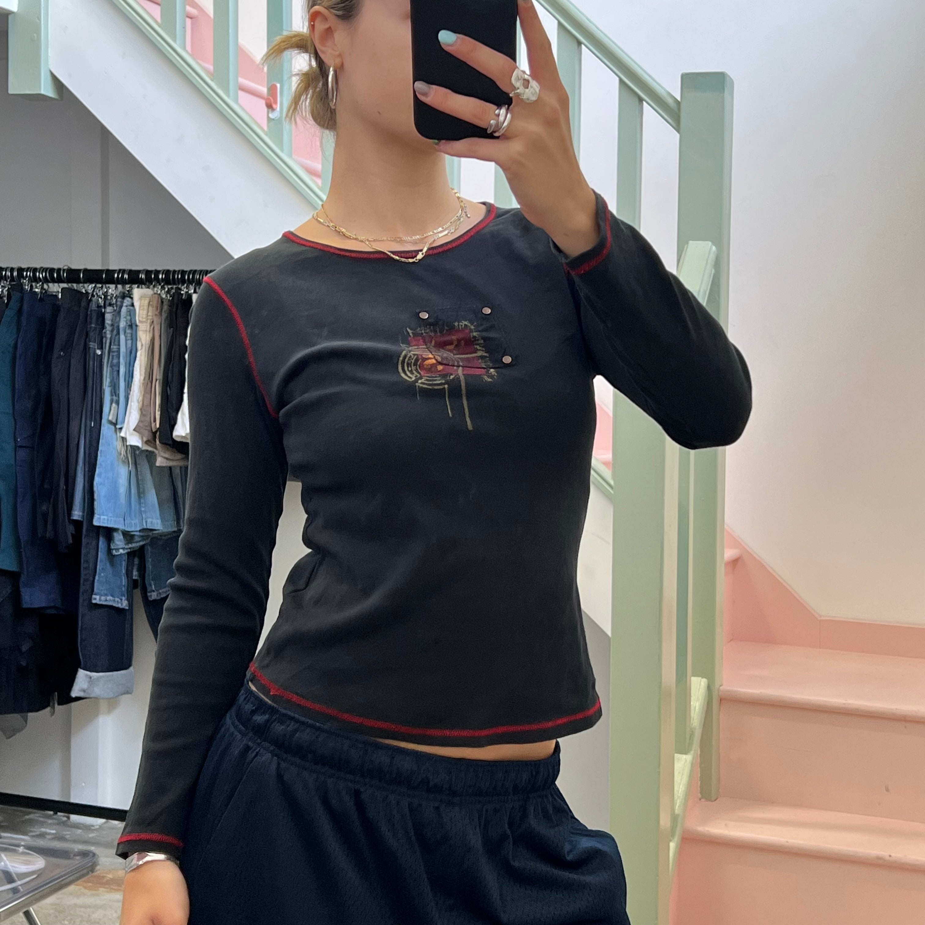 Black graphic top with red contrast stitch