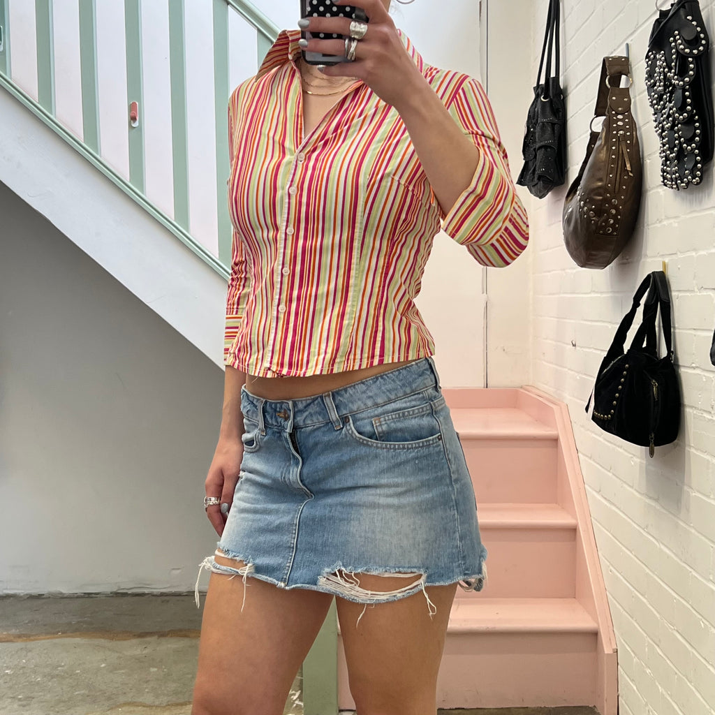 Distressed light wash denim mini skirt