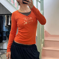 Cache orange top with pin detail