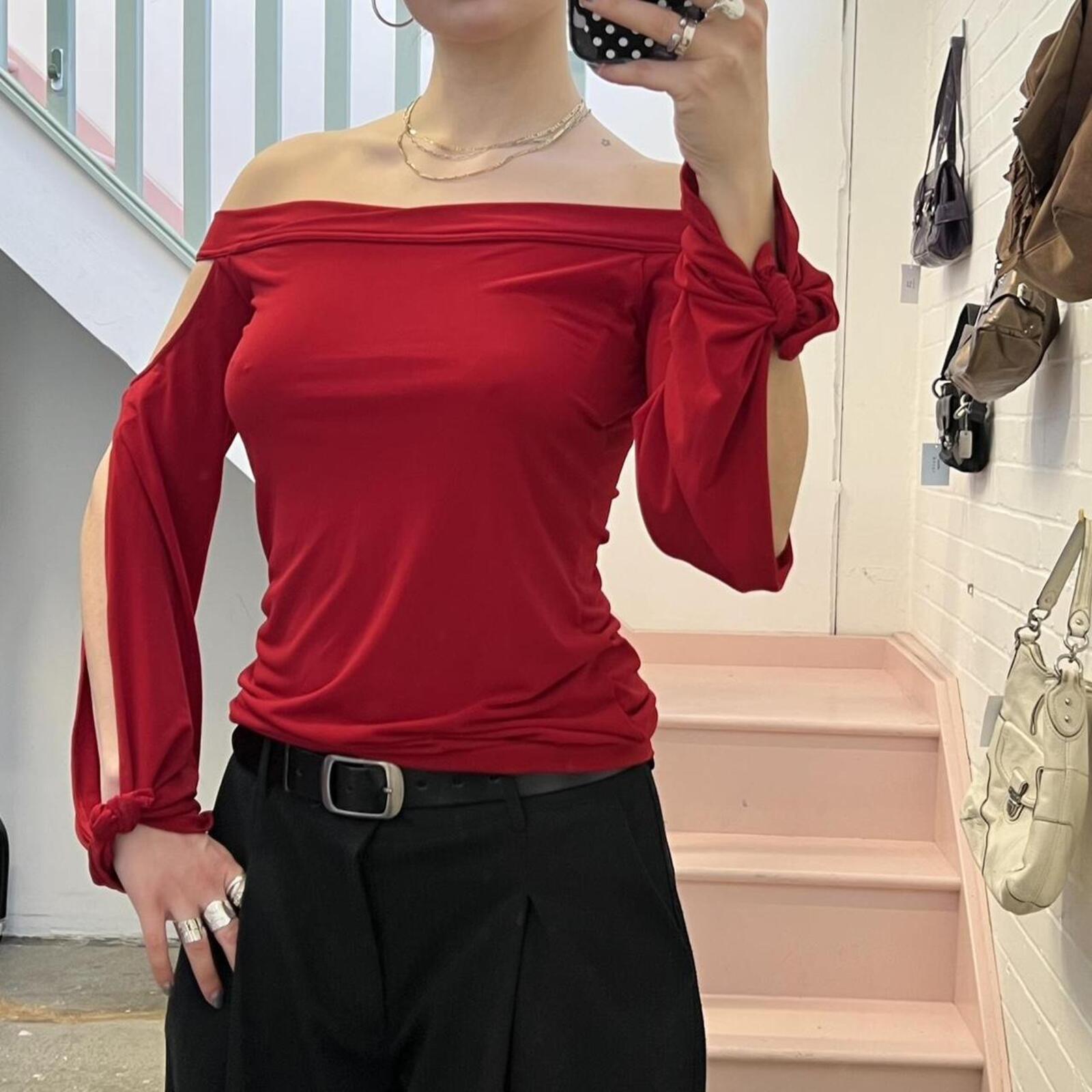 red slouchy off shoulder flared sleeve top with cutout detail