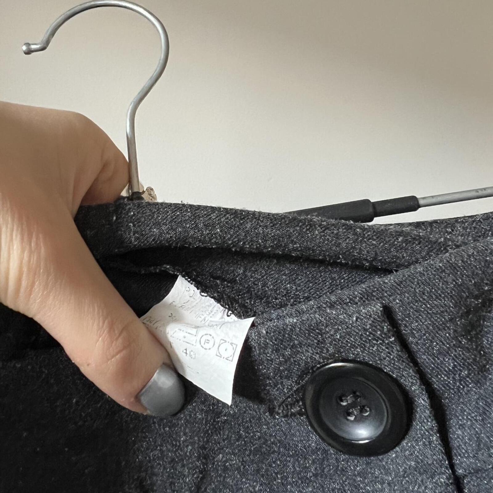 Grey low rise wide leg tailored trousers with oversized buttons on the waistband