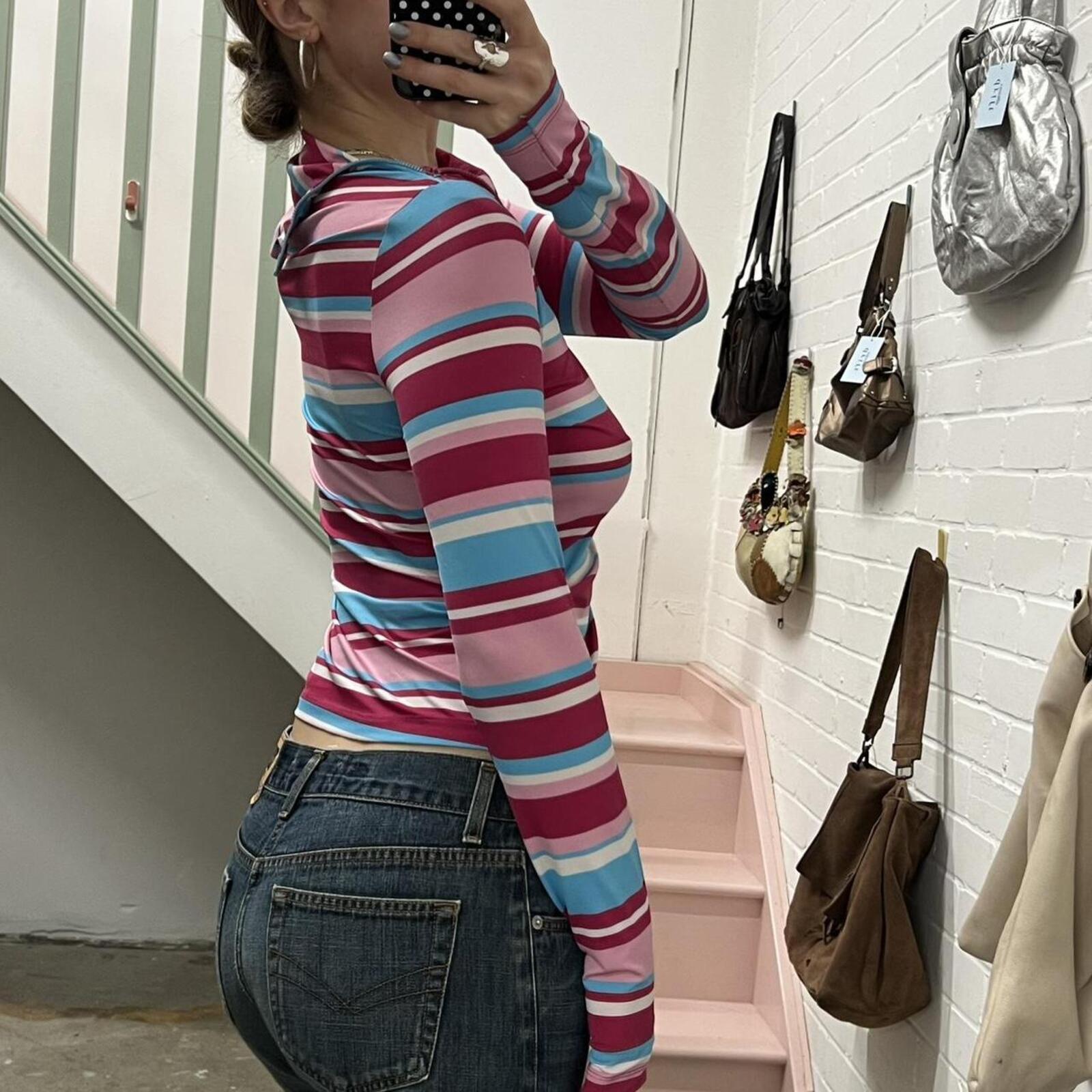 pink and blue striped high neck fitted top with zip detail