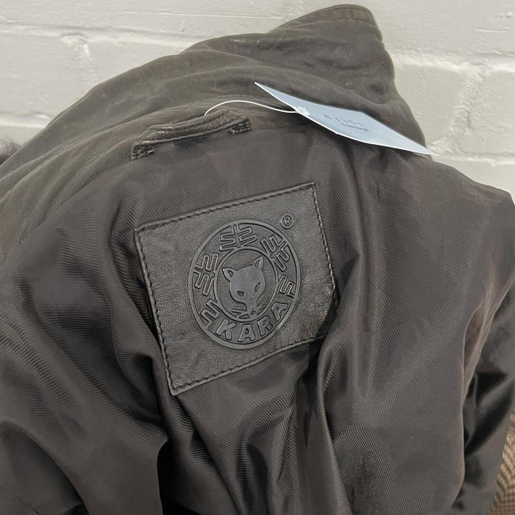 dark brown black vintage leather bomber jacket with silver buckles, oversized button and detachable fur trim hood