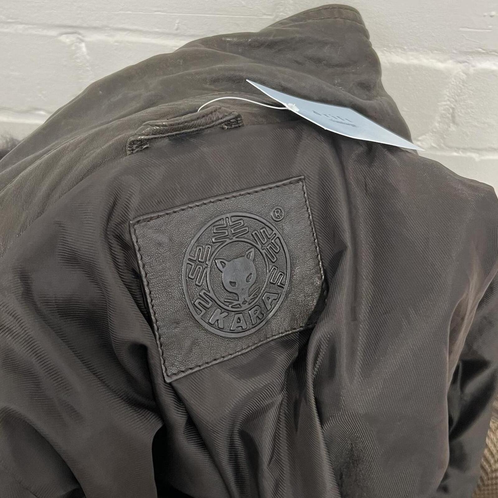 dark brown black vintage leather bomber jacket with silver buckles, oversized button and detachable fur trim hood