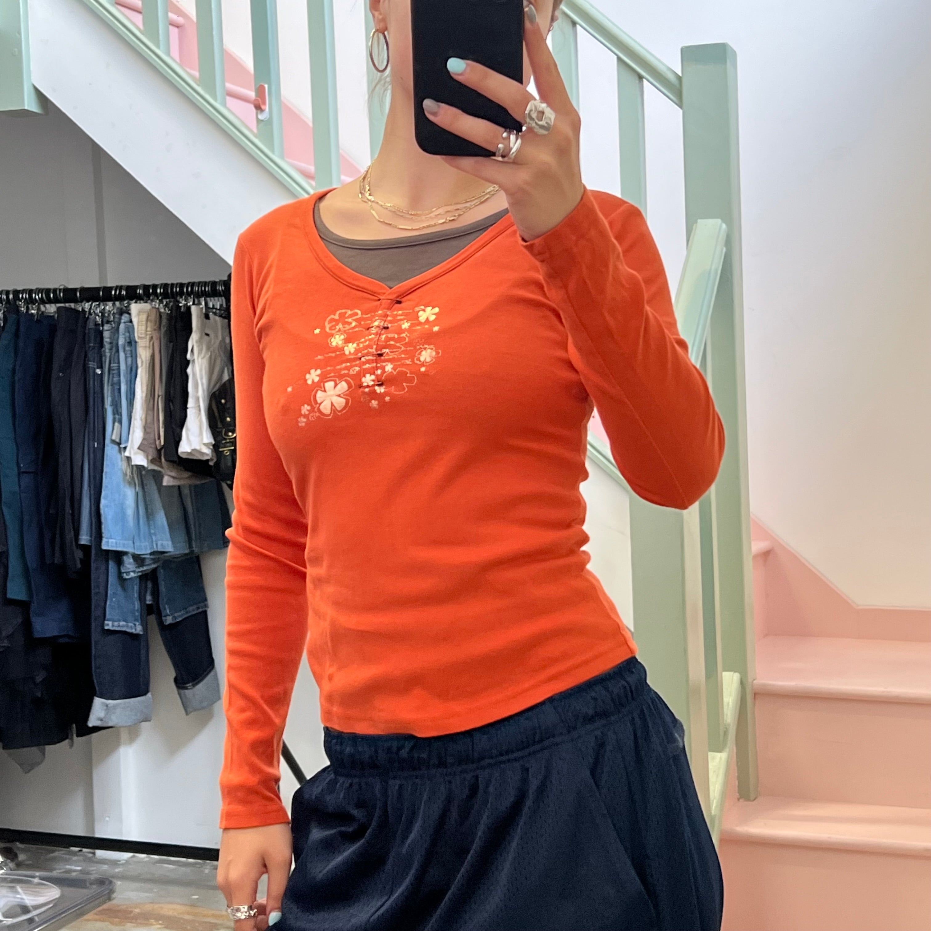 Cache orange top with pin detail