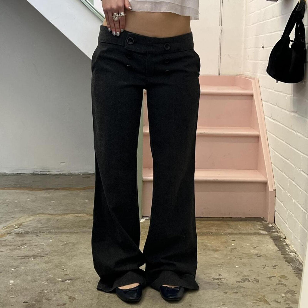 Grey low rise wide leg tailored trousers with oversized buttons on the waistband