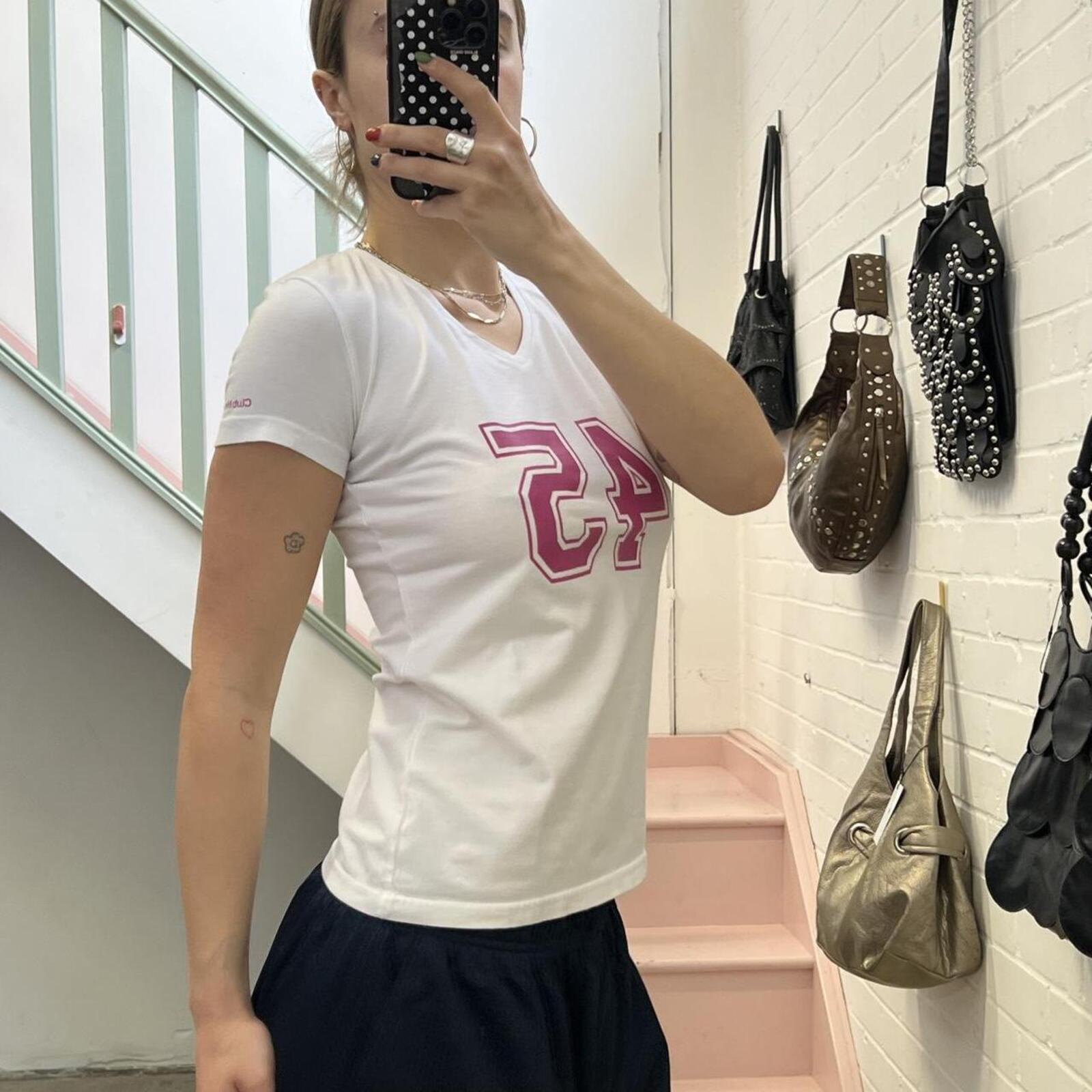 White fitted v neck baby tee with pink number print