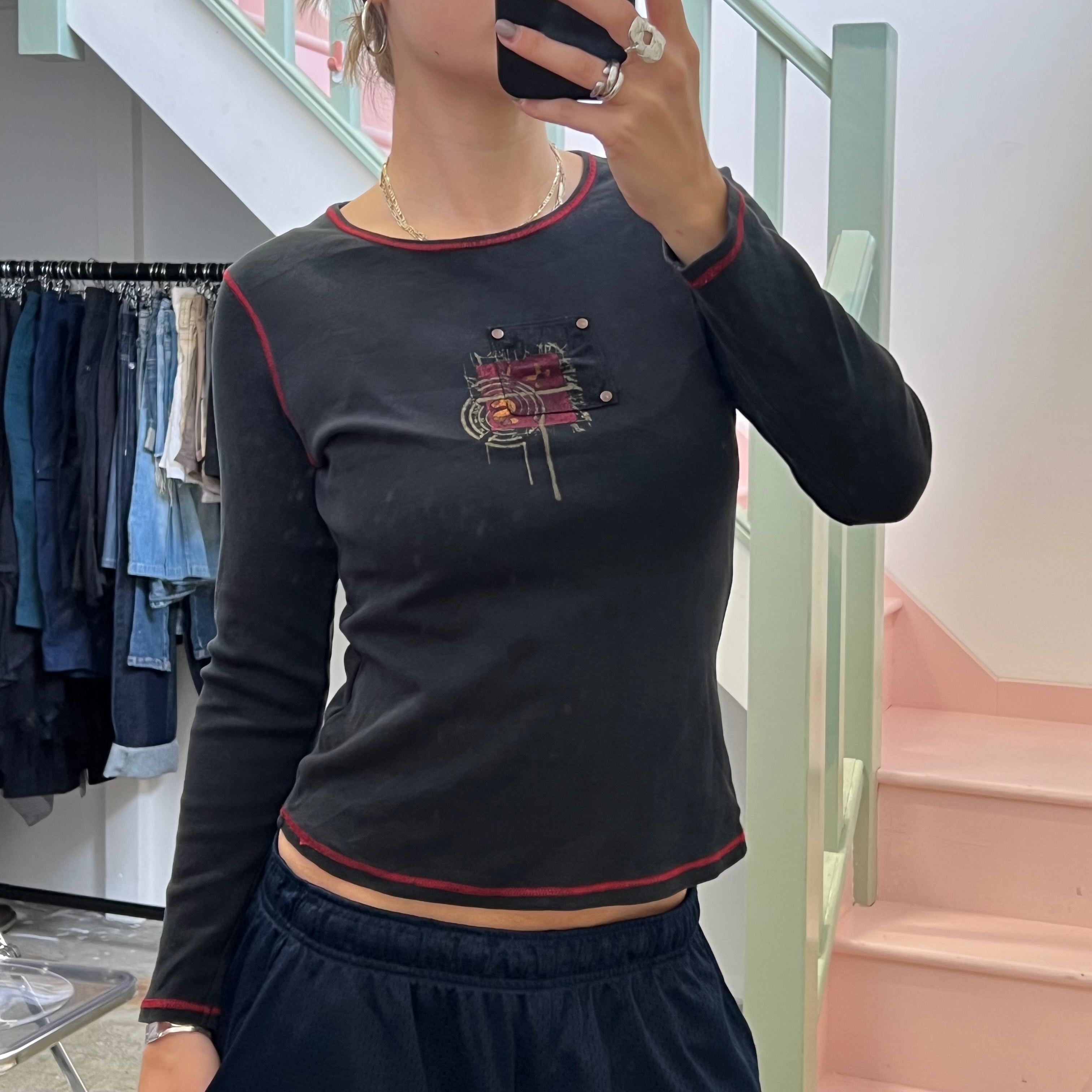 Black graphic top with red contrast stitch