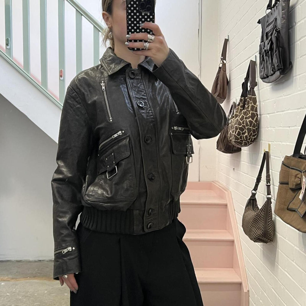dark brown black vintage leather bomber jacket with silver buckles, oversized button and detachable fur trim hood