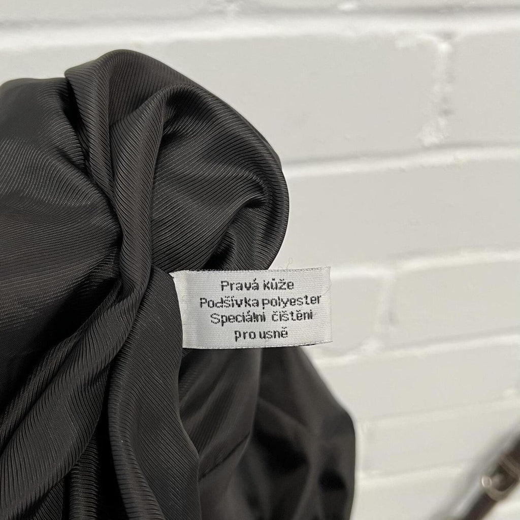 dark brown black vintage leather bomber jacket with silver buckles, oversized button and detachable fur trim hood
