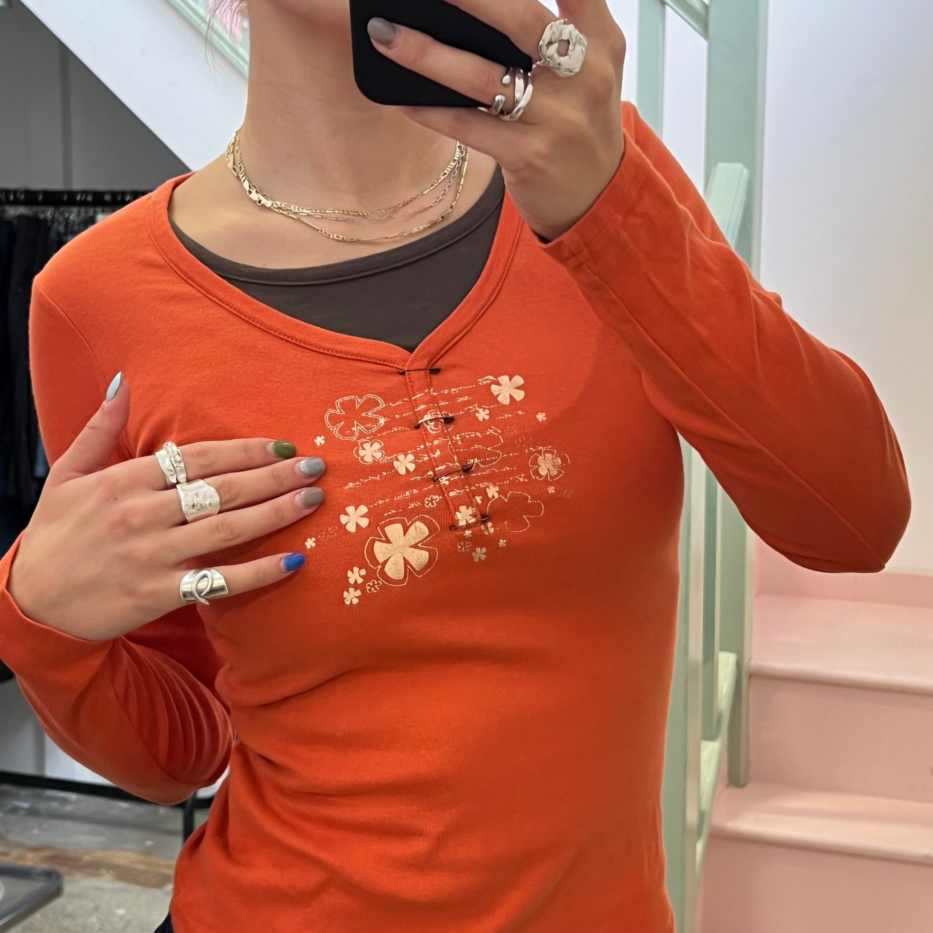 Cache orange top with pin detail