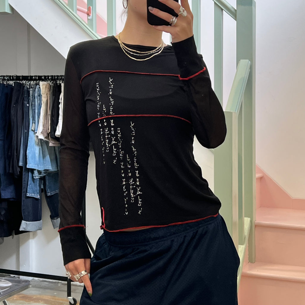 Black long sleeve top with red contrast stitch