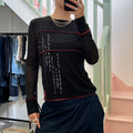 Black long sleeve top with red contrast stitch