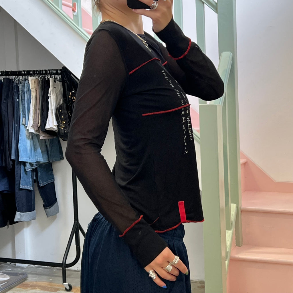 Black long sleeve top with red contrast stitch