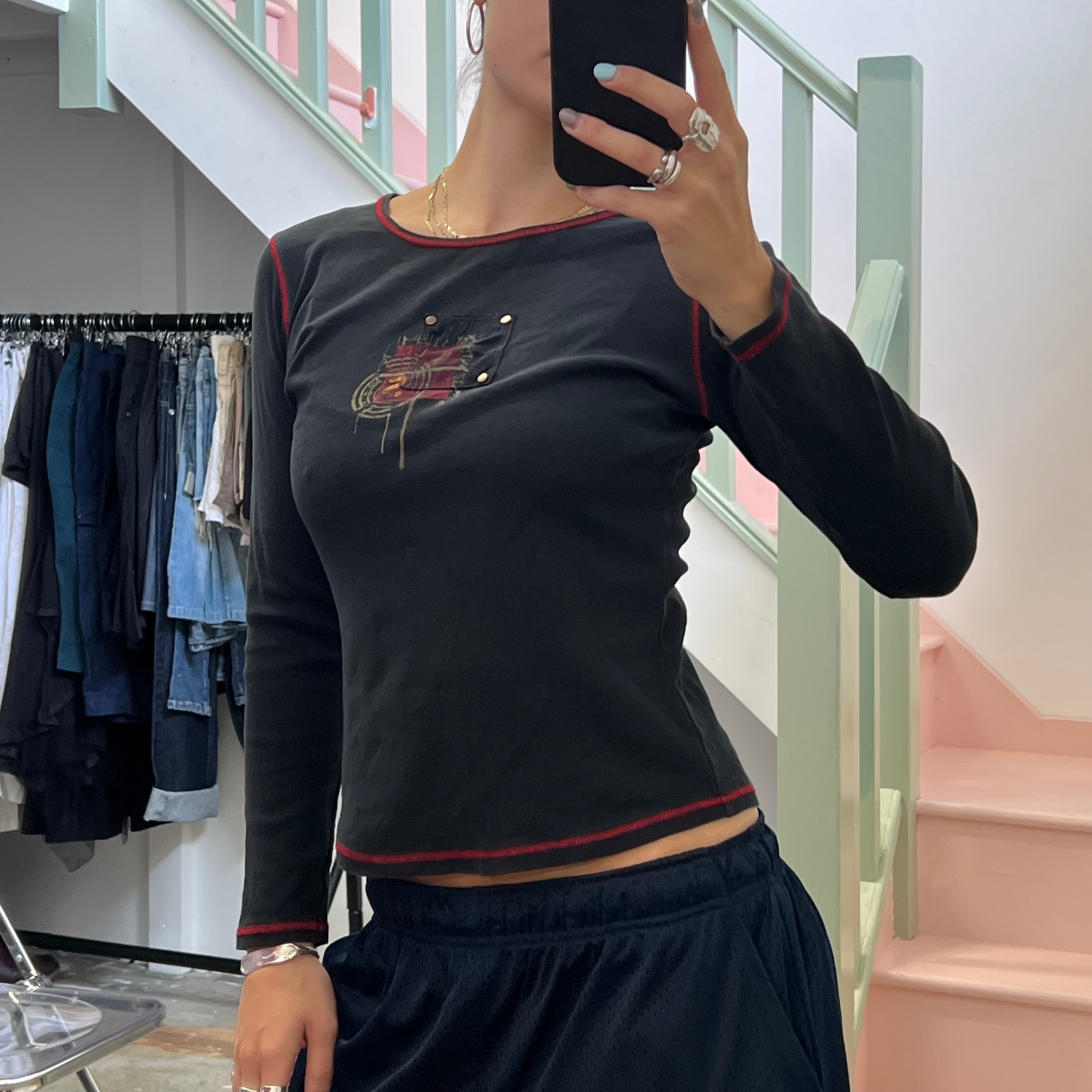 Black graphic top with red contrast stitch