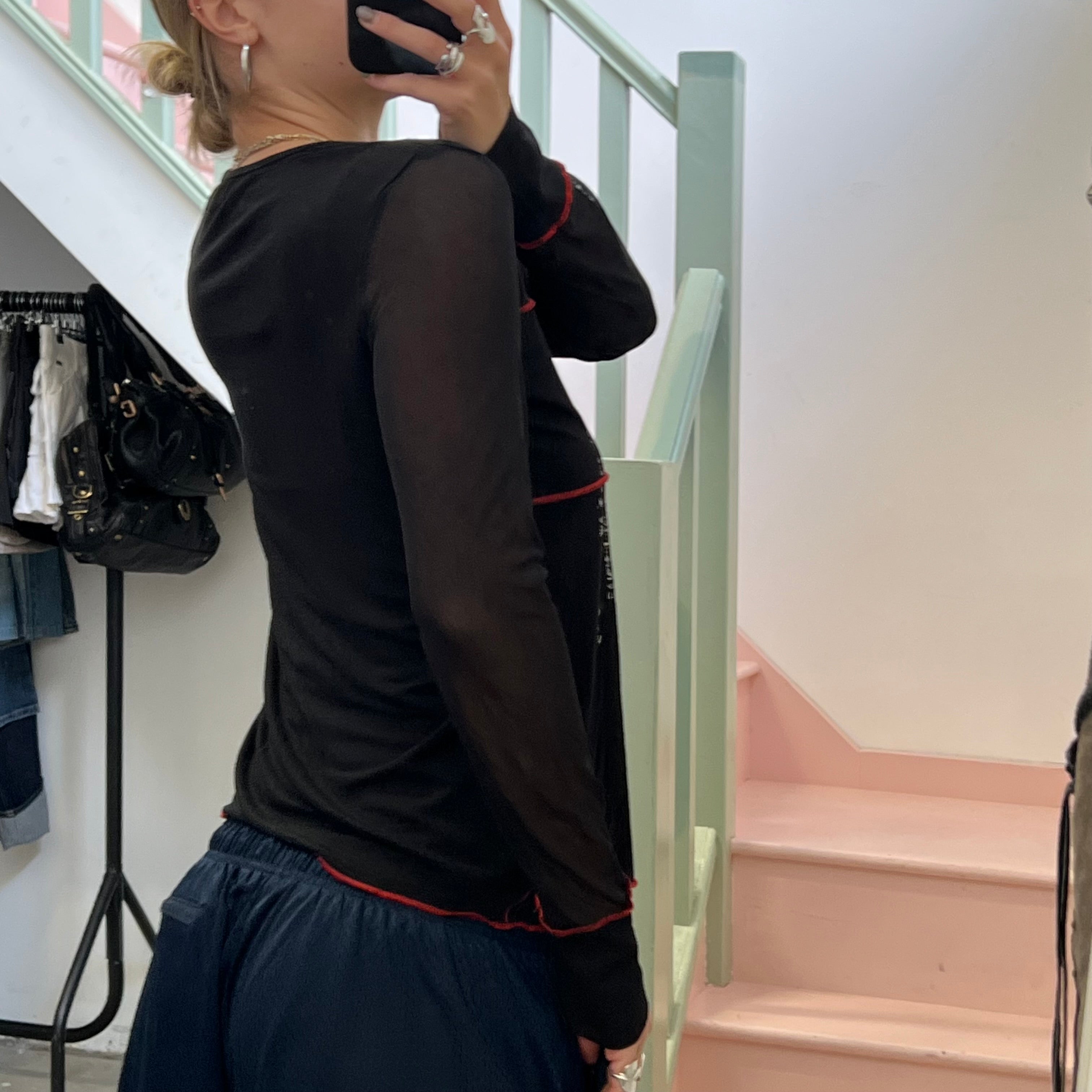 Black long sleeve top with red contrast stitch