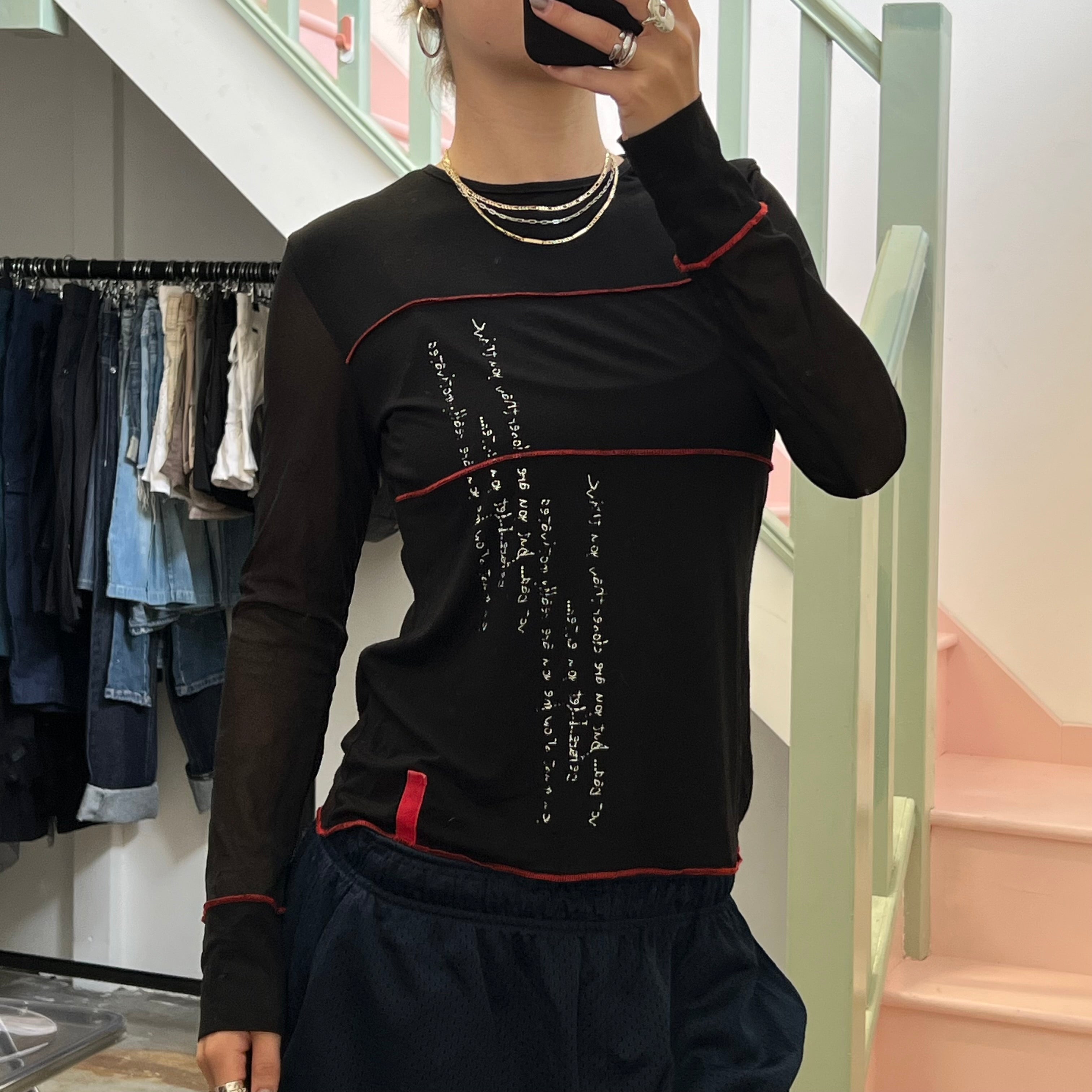 Black long sleeve top with red contrast stitch