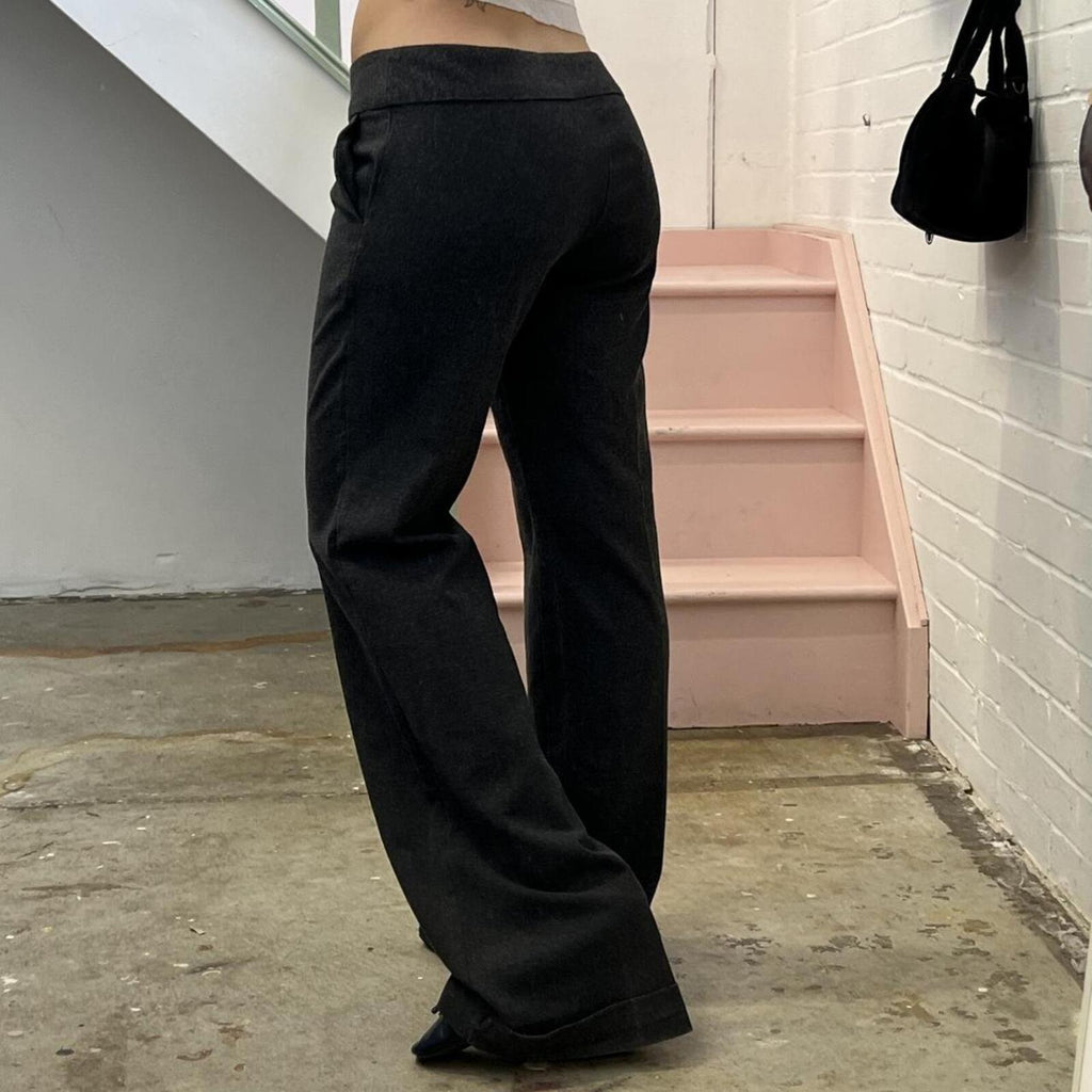 Grey low rise wide leg tailored trousers with oversized buttons on the waistband