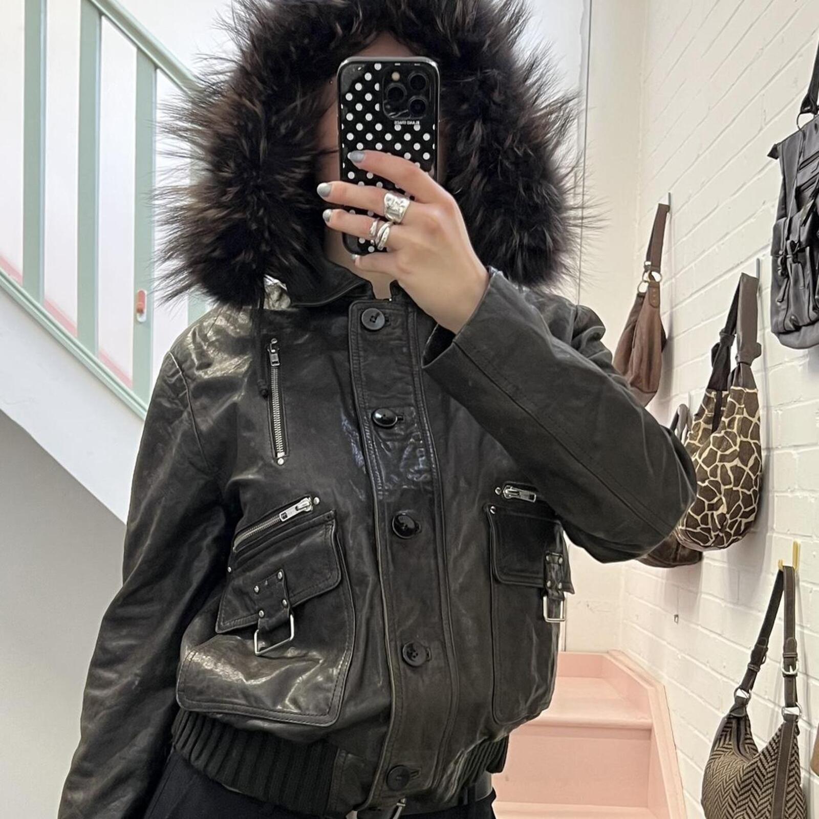 dark brown black vintage leather bomber jacket with silver buckles, oversized button and detachable fur trim hood