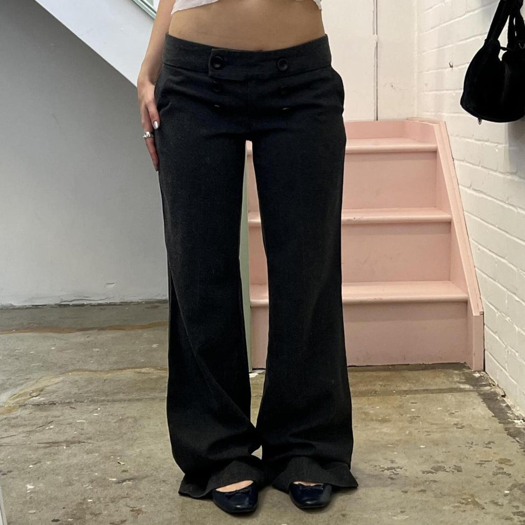 Grey low rise wide leg tailored trousers with oversized buttons on the waistband