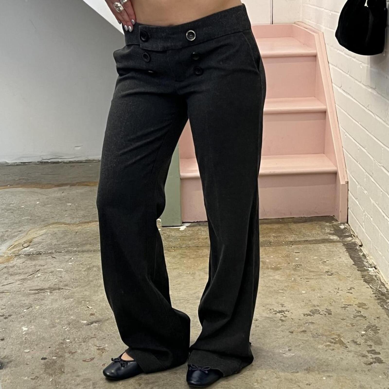 Grey low rise wide leg tailored trousers with oversized buttons on the waistband